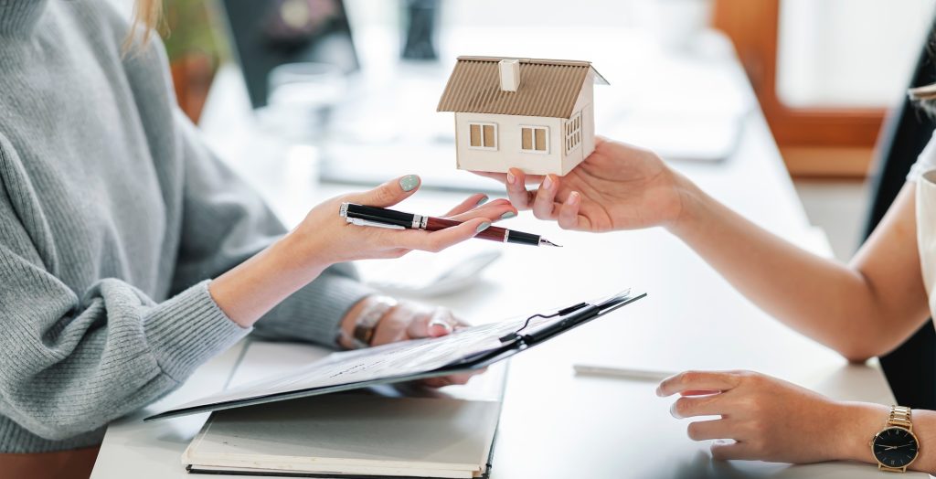 Real estate agreement concept. Real estate agents agree to buy a home and give a house to clients