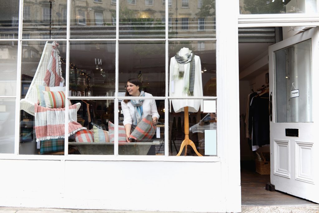 Shop owner arranging window display