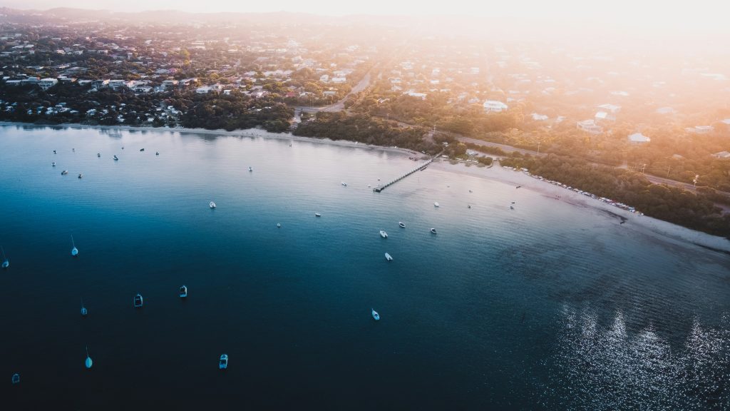"Aerial view of Rye and Blairgowrie coastline showing residential homes near the beach, highlighting popular investment property area on the Mornington Peninsula."